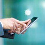 Closeup of a man using a digital tablet